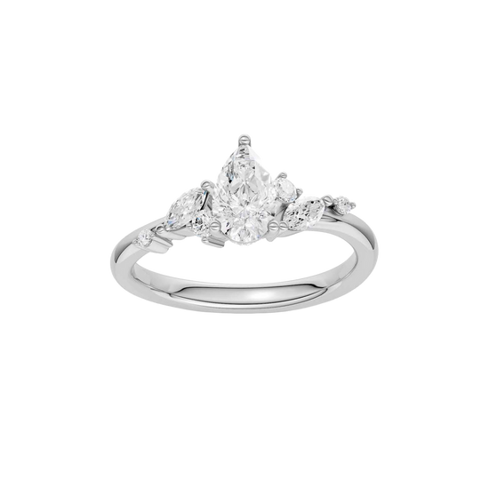 A top-down view of a 14K white gold ring with a three-stone cluster of round and pear-shaped gems.