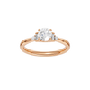 A top-down view of a 14K rose gold ring with a central round jewel and two smaller round gems on the sides.