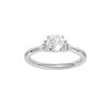 A top-down view of a 14K white gold ring with a central round jewel and two smaller round gems on the sides.