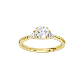 A top-down view of a 14K yellow gold ring with a central round jewel and two smaller round gems on the sides.