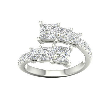 A top-down view of a 14K white gold ring with an asymmetrical cluster of princess-cut and baguette diamonds.
