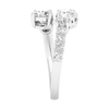 Side view of a white gold bypass ring demonstrating the unique "floating" architecture of the diamond clusters. The image shows the polished interior of the 14K gold shank and the precision pavé detailing along the shoulder.
