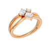 An angled view of a 14K rose gold bypass ring, showcasing the baguette cluster and the curved band.