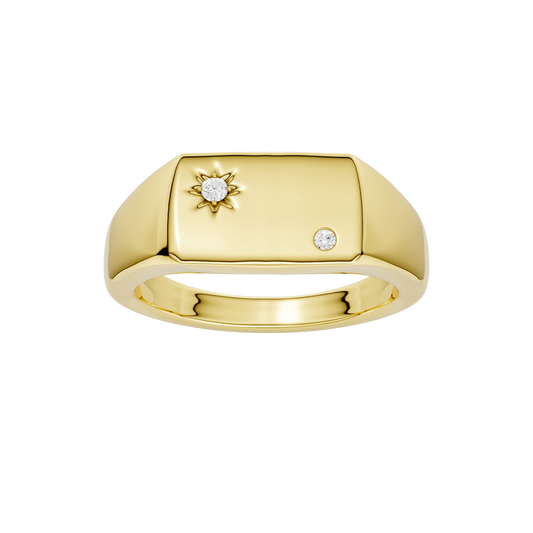 A top-down view of a 14K yellow gold signet ring with a sunburst motif and a brilliant round jewel.