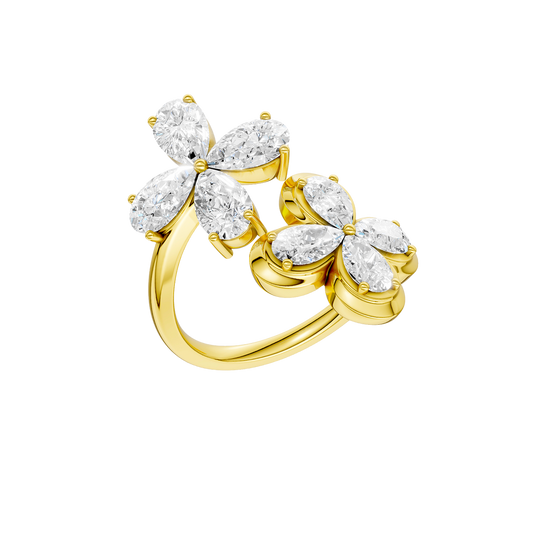 Angled view of a yellow gold floral diamond ring highlighting the dimensional flower motif, marquise-cut white diamond sparkle, and high-polish gold finish.